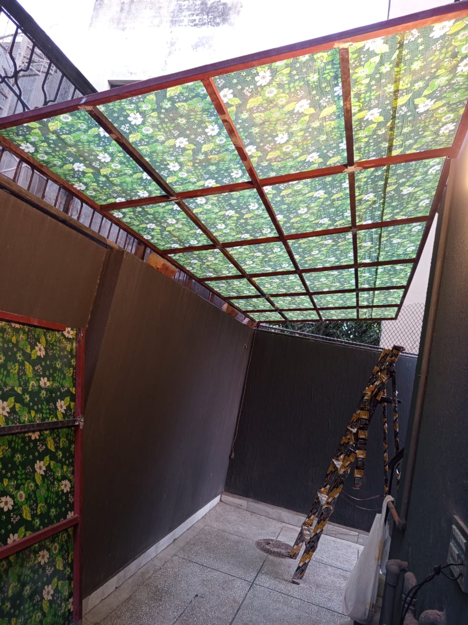 Covered outdoor area with a timber-framed patterned roof canopy