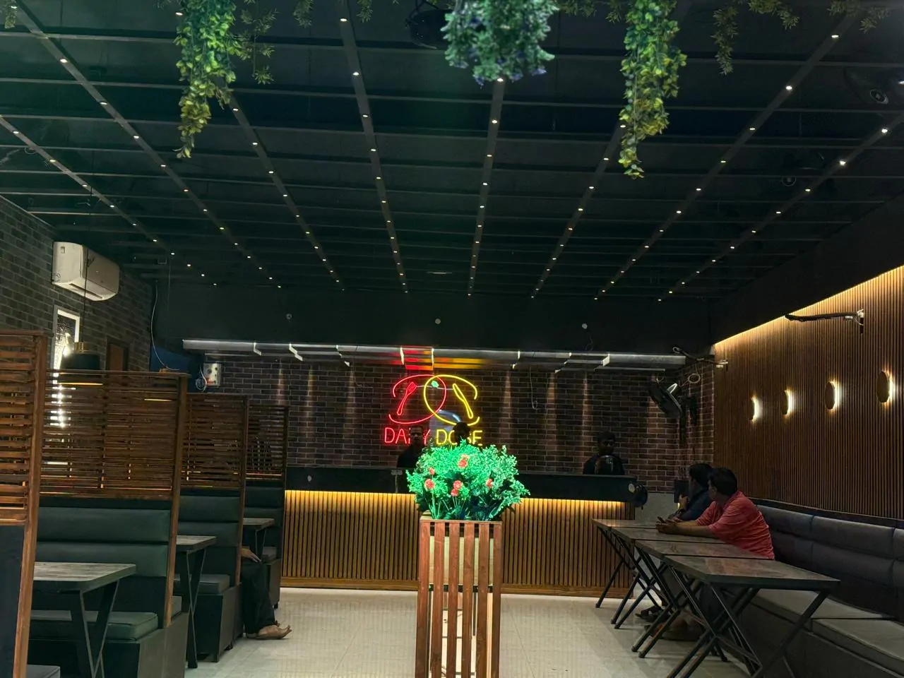 Dining hall view towards the backlit service counter and neon logo
