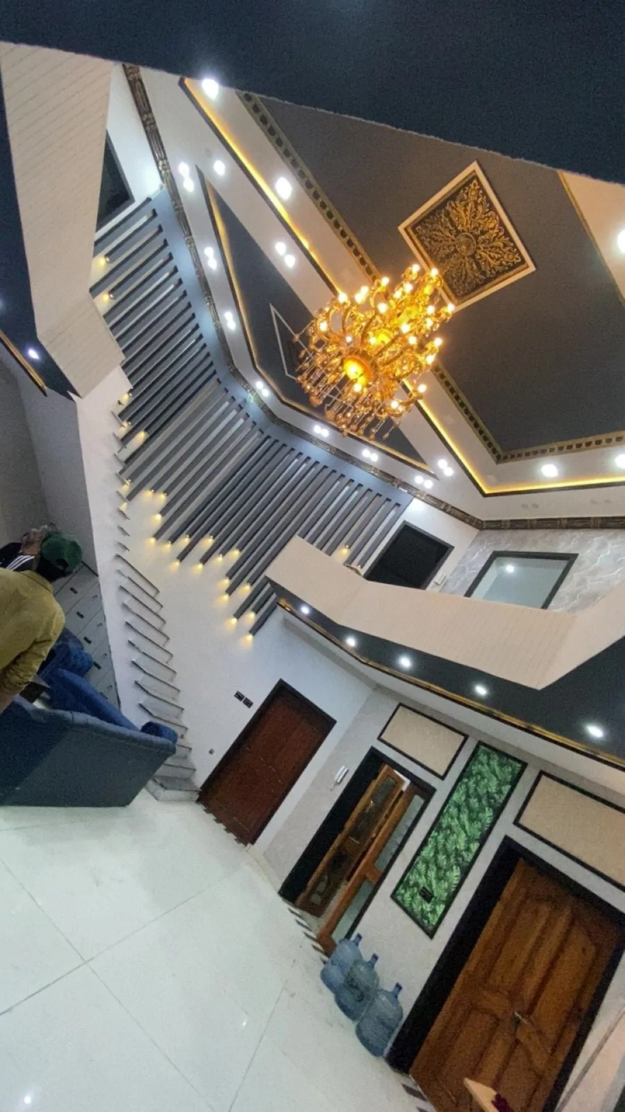 View up the staircase hall towards the upper gallery and chandelier