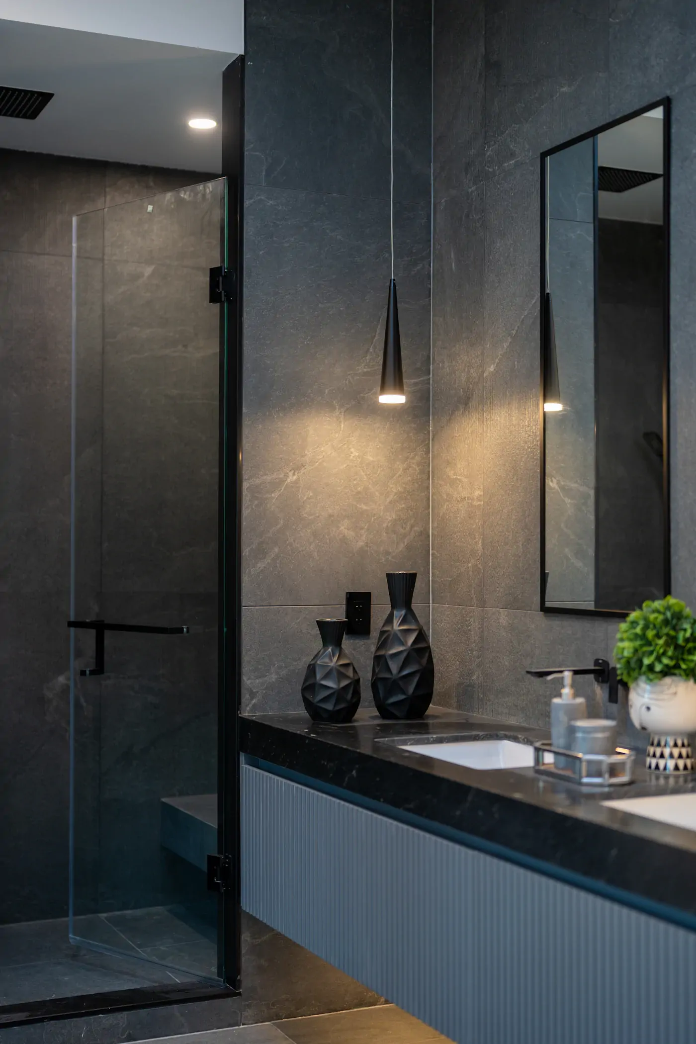 Dark stone vanity detail in a modern bathroom