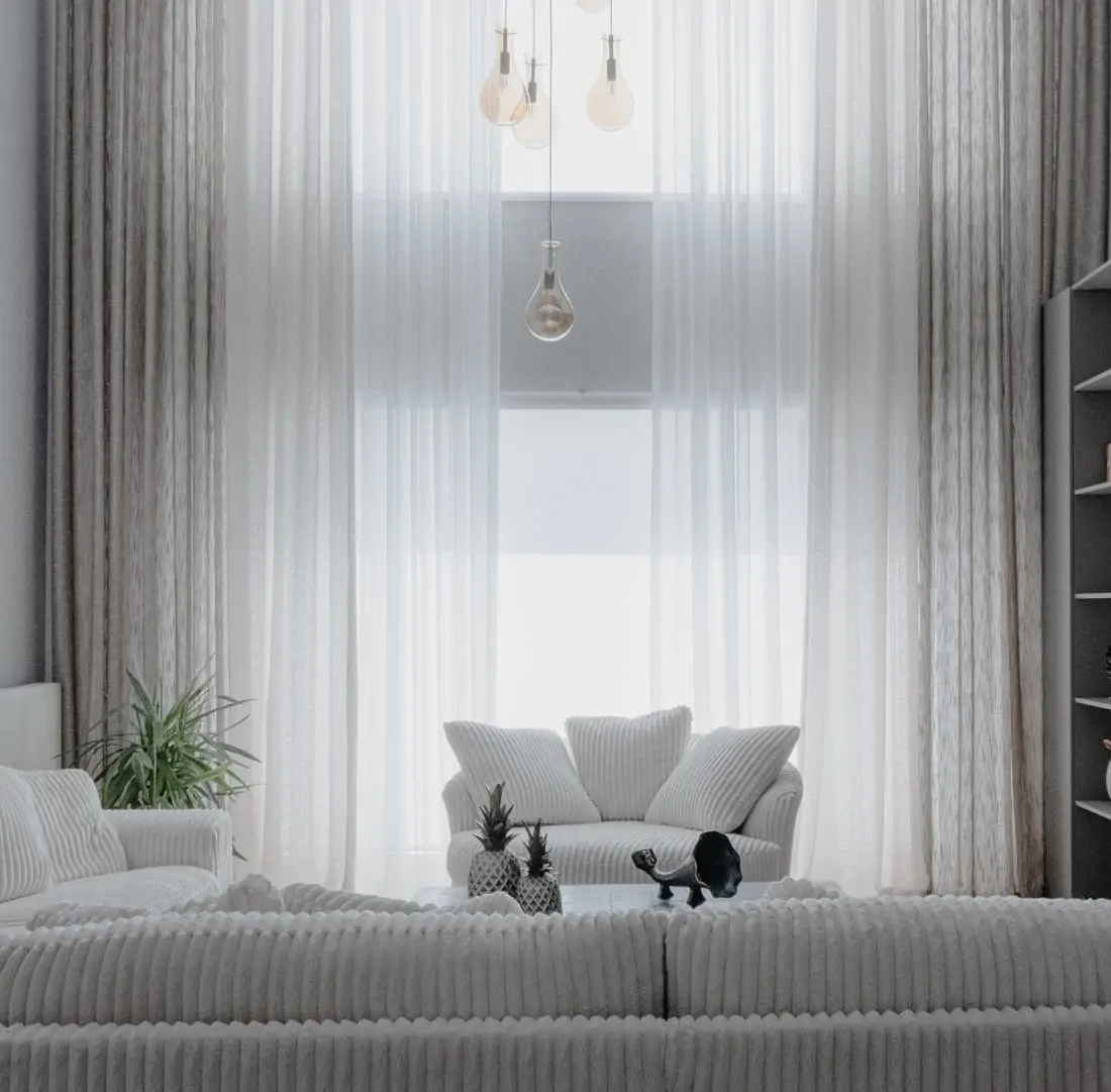 Private residence living room with white sofas and curtains